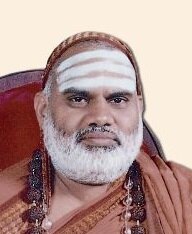 Head-and-shoulders portrait of Jagadguru Sri Bharati Tirtha Mahaswamiji with vibhuti on his forehead and a saffron shawl over his head
